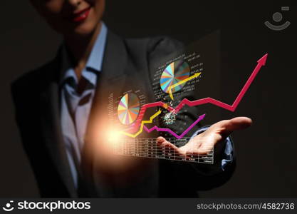 Growth concept. Close up of businesswoman holding graphs in hand