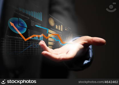 Growth concept. Close up of businesswoman holding graphs in hand