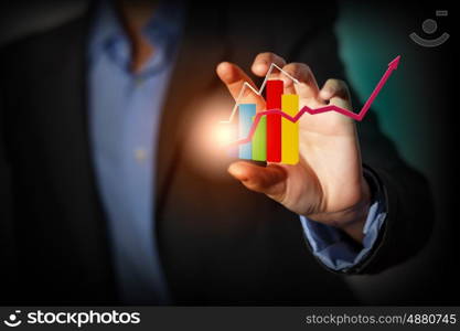 Growth concept. Close up of businesswoman holding graphs in hand