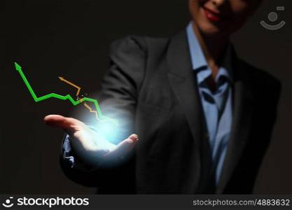 Growth concept. Close up of businesswoman holding graphs in hand