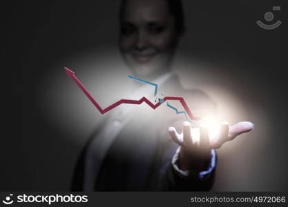 Growth concept. Close up of businesswoman holding graphs in hand