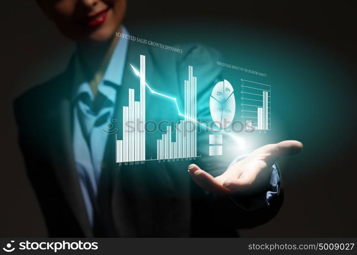 Growth concept. Close up of businesswoman holding graphs in hand