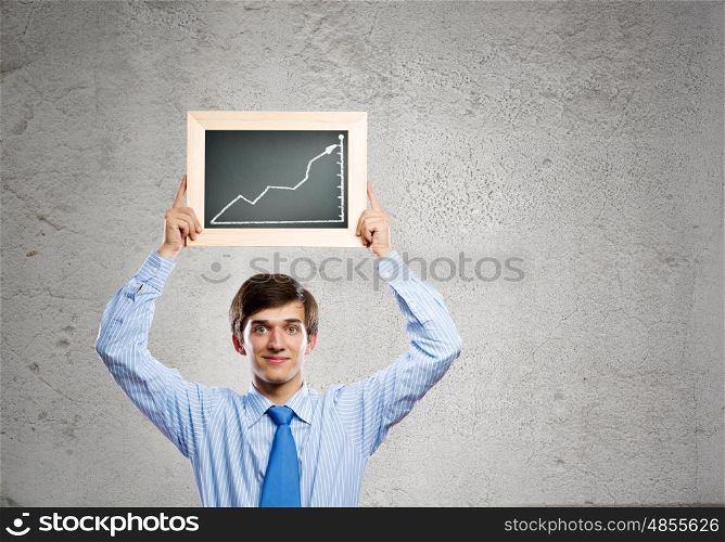Growth concept. Handsome businessman holding frame with graph drawing