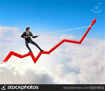 Growth concept. Image of businessman standing on graph and pulling it upwards