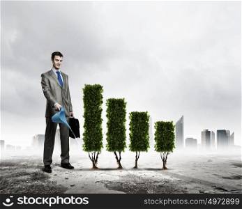 Growth concept. Image of businessman watering plant shaped like graph