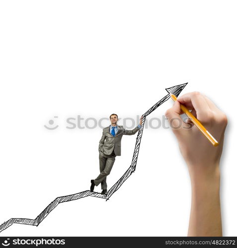 Growth concept. Young businessman standing on drawn graph arrow