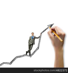 Growth concept. Young businessman standing on drawn graph arrow