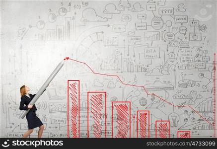 Growth concept. Young businesswoman drawing growing graph with huge pencil