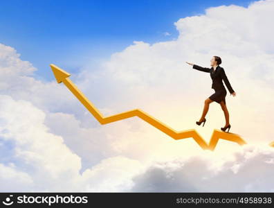 Growth concept. Young businesswoman walking on increasing graph high in sky