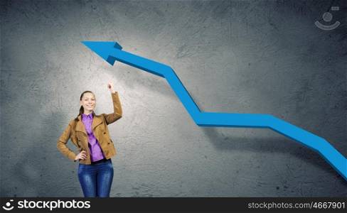 Growth concept. Young pretty woman pointing at increasing graph