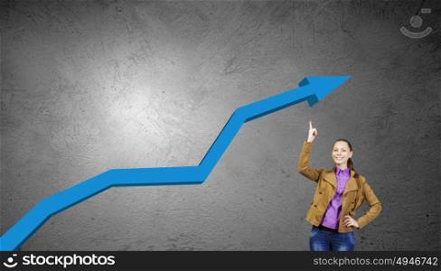 Growth concept. Young pretty woman pointing at increasing graph