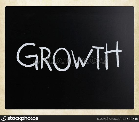 ""Growth" handwritten with white chalk on a blackboard."