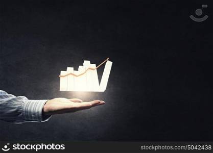 Growth in business. Close up of businesswoman holding graphs in hand