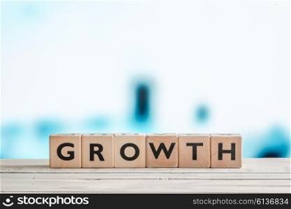 Growth sign made of wooden cubes on blue background
