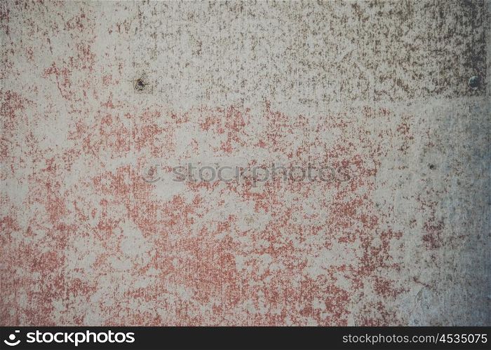 Grunge background of a concrete wall with torn red paint