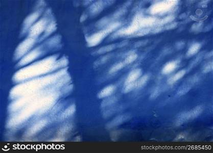 Grunge blue mediterranean garden texture wall, light and shadows