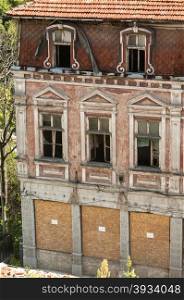 Grunge broken windows of old neglected abandoned vintage building