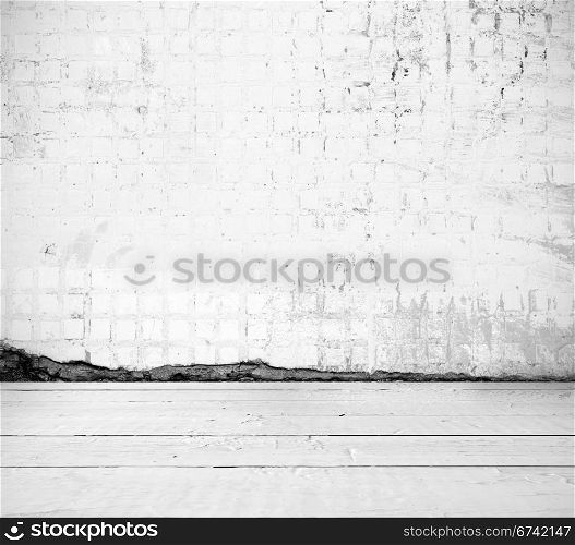 Grunge interior tiled wall and wooden floor