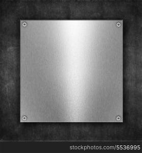 Grunge metal background with shiny metal plate