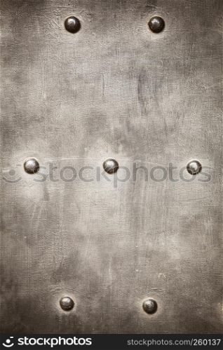 grunge metal plate or armour texture with rivets as background. grunge metal plate as background texture