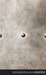 grunge metal plate or armour texture with rivets as background. grunge metal plate as background texture