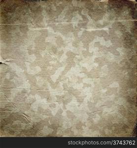 Grunge military background. Camouflage pattern on a paper texture. Grunge military background with a texture of paper