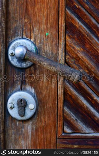 grunge old door knob, wooden texture on the doors for background.