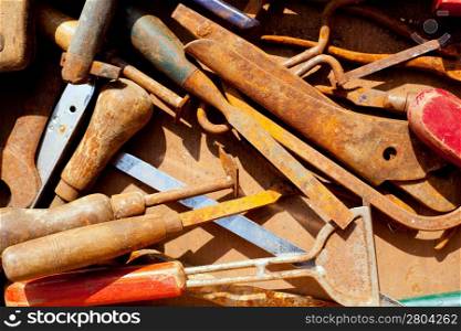 grunge rusty hand tools in messy arrangement