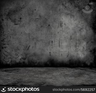 Grunge style image of a room interior with concrete wall and metal floor