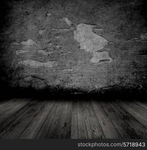 Grunge style image of an old interior with peeling walll and wooden floor
