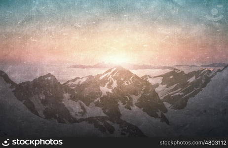 Grunge styled lanscape. Natural beautiful landscape of sunrise above mountains