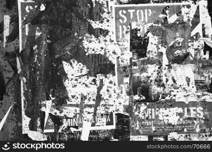 Grunge textured background with torn posters. Black and white image