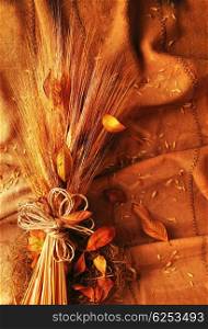 Grunge wheat background with autumn leaves