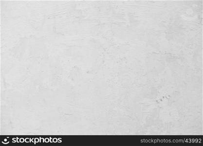 Grunge White Concrete Wall Background. Grungy white concrete wall background. Background from high detailed fragment stone wall. Cement texture. Grey concrete wall.