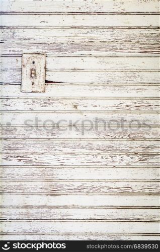 grunge white painted wood wall background with an electric switch