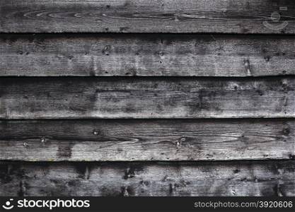 grungy background consisting of part of old black and grey wooden barn wall