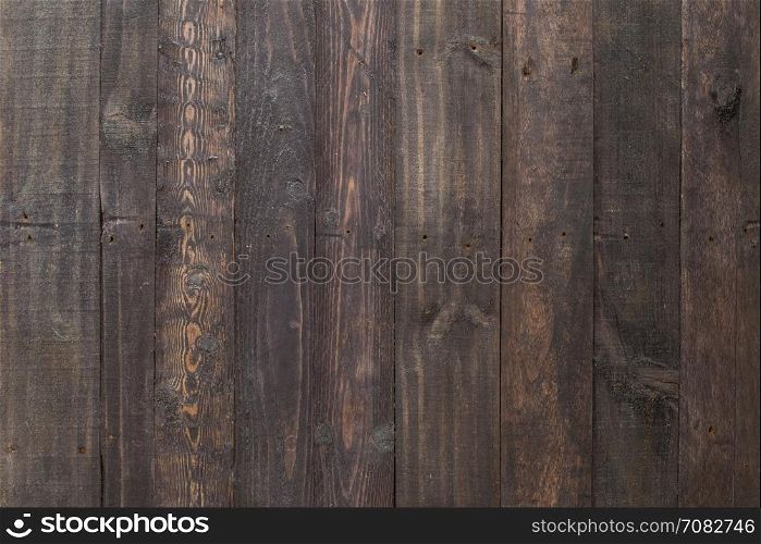 Grungy black paintwork on a wooden panel