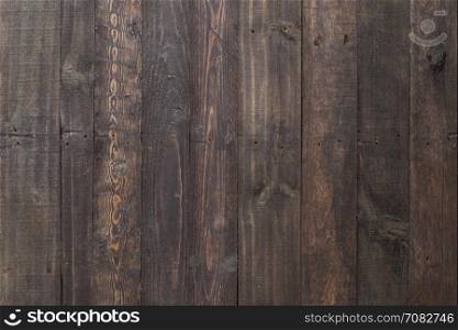 Grungy black paintwork on a wooden panel