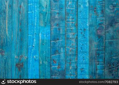 Grungy blue paintwork on a wooden panel