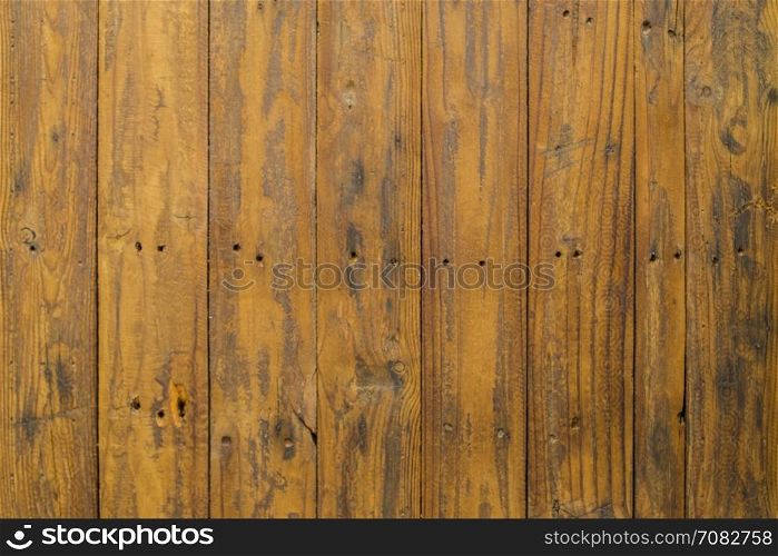 Grungy brown paintwork on a wooden panel