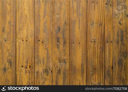 Grungy brown paintwork on a wooden panel