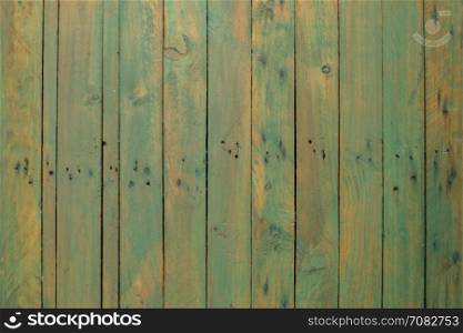 Grungy green paintwork on a wooden panel