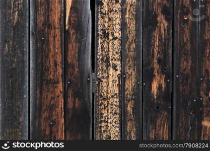 Grungy texture of weathered wooden planks burnt on edges
