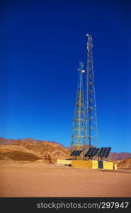 gsm towers with solar panels in the mountains