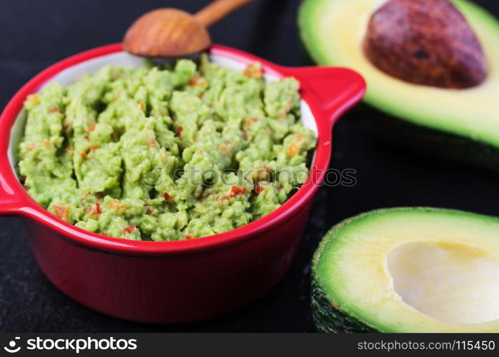 Guacamole. Guacamole in a bowl on a wooden