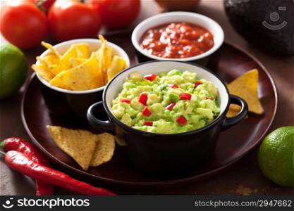 guacamole with avocado, lime, chili and tortilla chips, salsa