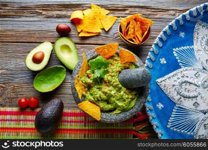 Guacamole with nachos avocado in Mexican molcajete and Sombrero hat
