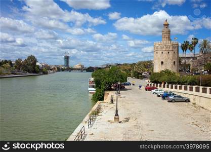 Guadalquivir river embankment and Torre del Oro (Gold Tower) in Seville, Spain.