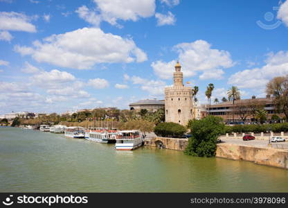 Guadalquivir river waterfront and Torre del Oro (Gold Tower) in Seville, Spain.