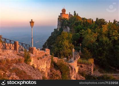 Guaita fortress or Prima Torre on the ridge of Mount Titano, in the city of San Marino of the Republic of San Marino during gold hour at sunset. Guaita fortress in San Marino